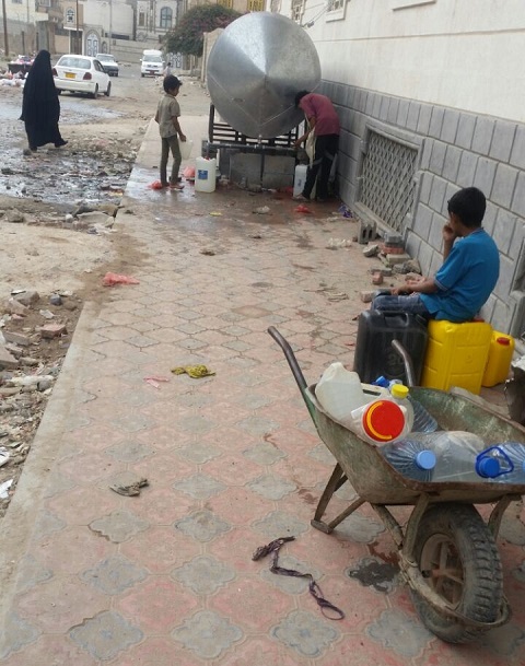 Children getting water from public water tanks