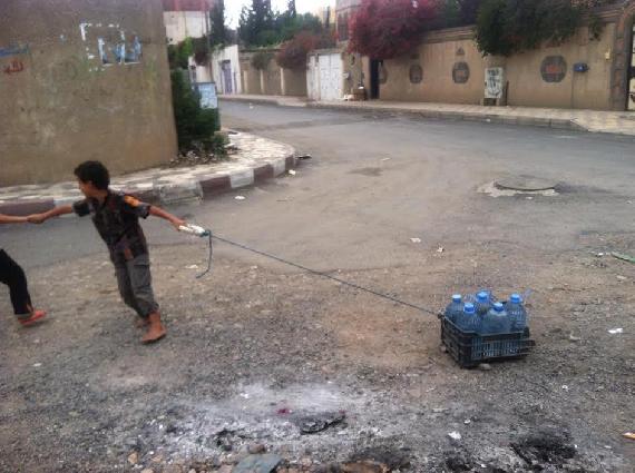 ​Another photo of the children hardship of water pulling.