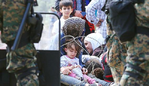 Close up of refugee family on Greece side of border facing Macedonia Border control