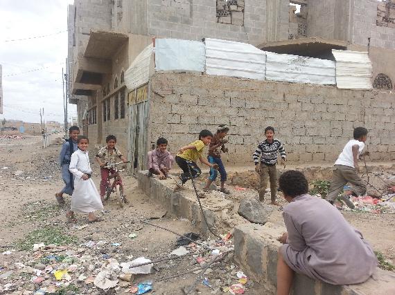 Displaced children are playing ignoring the aircrafts