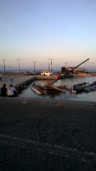 Multiple scuttled boats in the harbor piled together