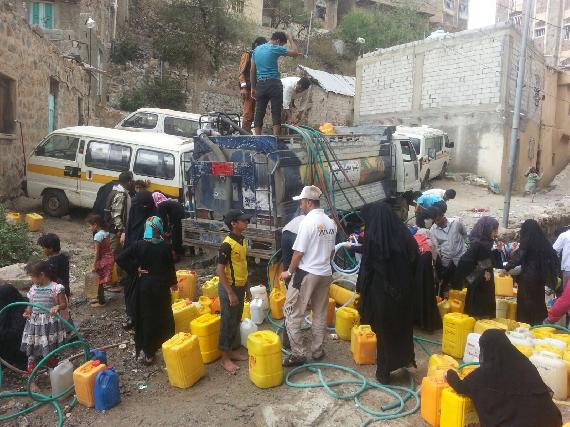 Women and children collecting water from a water station (Photographer: Correspondent #14)