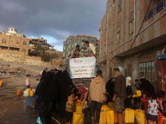 Several families obtaining water from distribution point