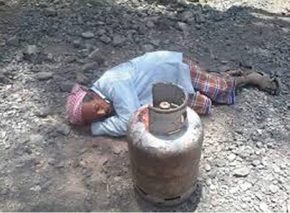 An old man falls asleep beside a gas cylinder after he get tired from carrying it (cell phone image from citizen)