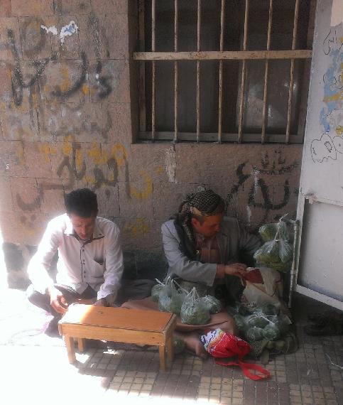 Mohammed Algubari, in his neighborhood, while selling qat. (Photographer: Hisham Khalid)