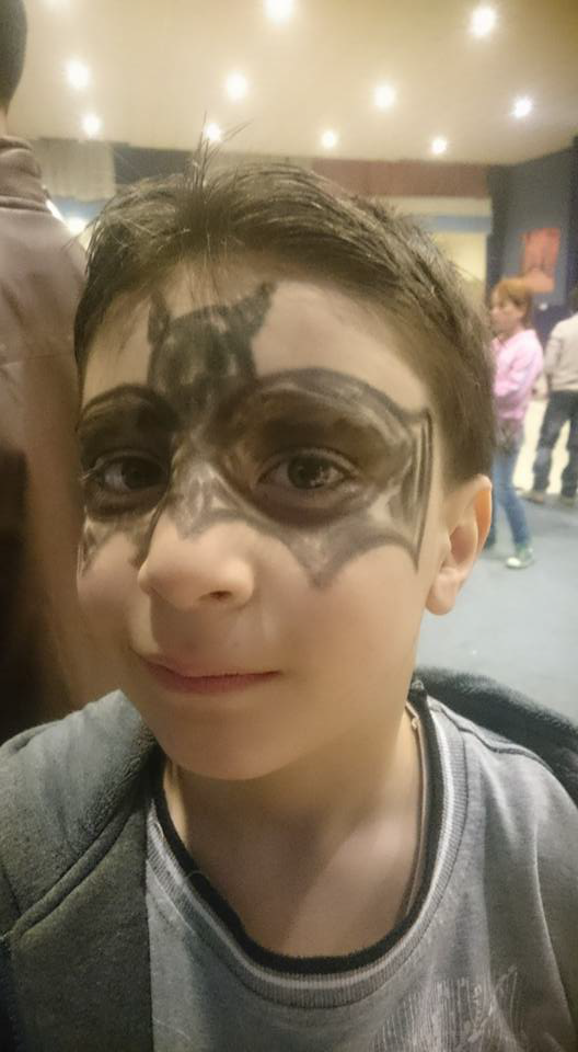 A Syrian child with face painted