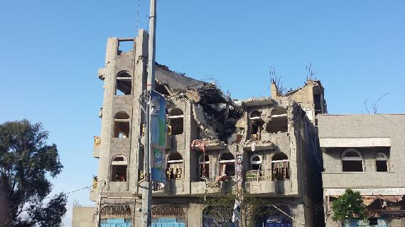 Exterior view of damaged residential building containing the Al-Qadsi family home