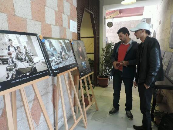 Our Correspondent talking to a Visitor at the Yemen Photo Exhibition for Children in Conflict on April 8, 2016