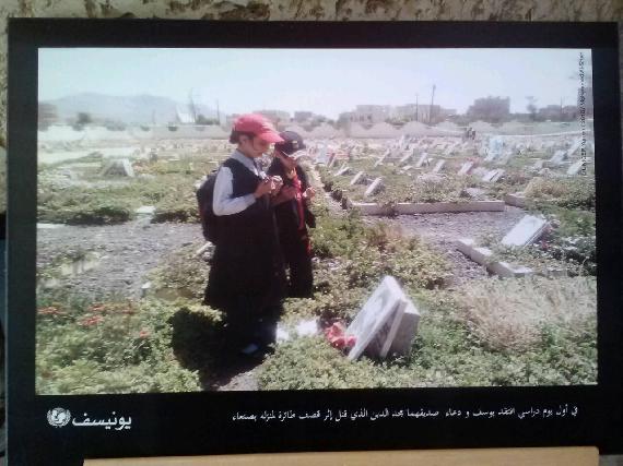 A picture in the exhibition of two children overlooking the burial site of a family member whom perished in the conflict
