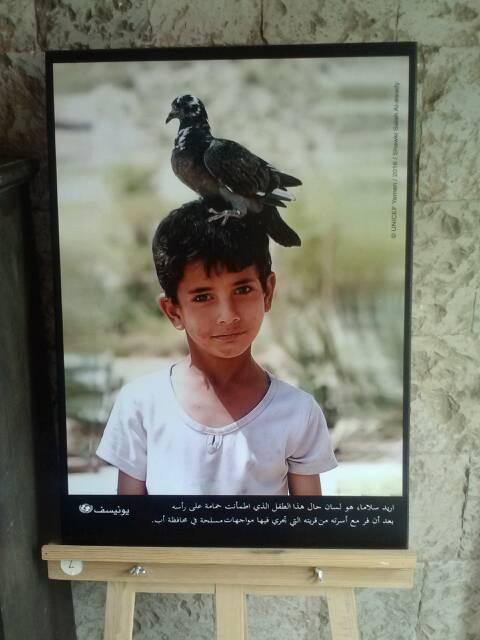 A photograph in the exhibition of a young Yemeni boy