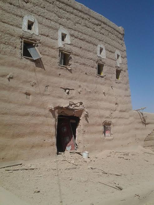 Buildings in al-Gail district still standing have doors and windows blown out from shock waves from air strikes