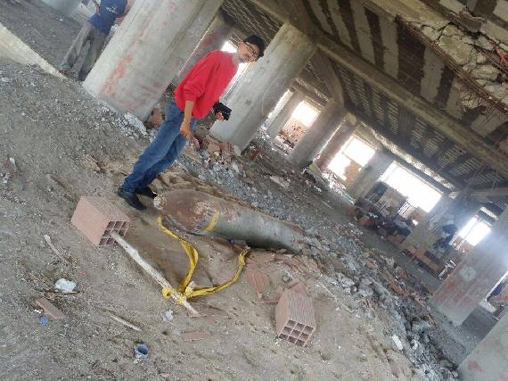 Our reporter looking at the unexploded missile on the second floor of the 7-story building previously occupied by the Houthi militia as a command post