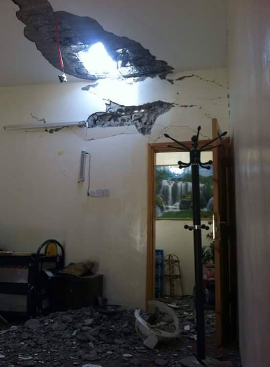 An interior view of a room in Khalid’s home where a shell pierced through the ceiling.