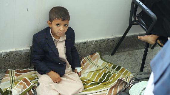 A child sitting on the floor of the Emergency Department in Al-Sabeen Maternity and Child Hospital, there are no available beds, he has to wait. (Photographer: Hemiar Alazab)