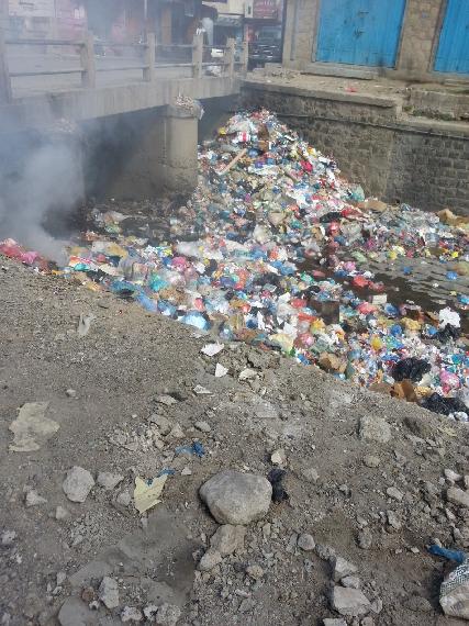 Unhealthy fumes emitted from garbage rotting in the streets