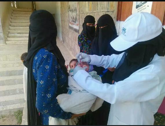 Mothers receiving medication and vaccinations of their young children and infants at the clinic